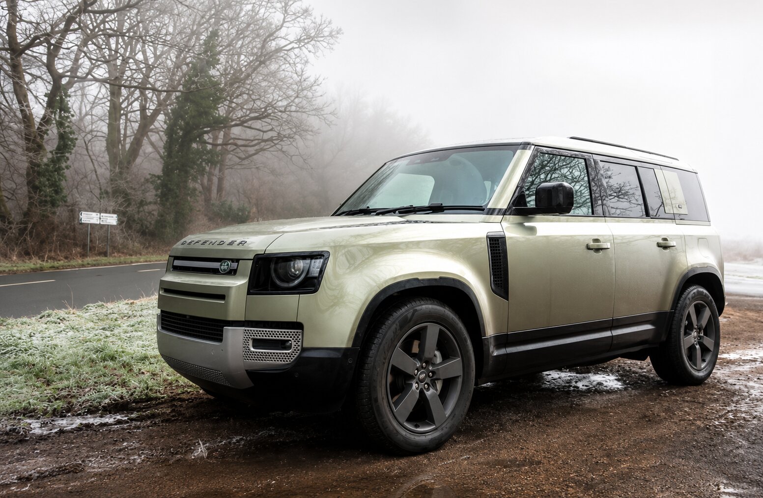 Green Land Rover Defender on a misty road — Land Rover and Range Rover Lemon Law claims
