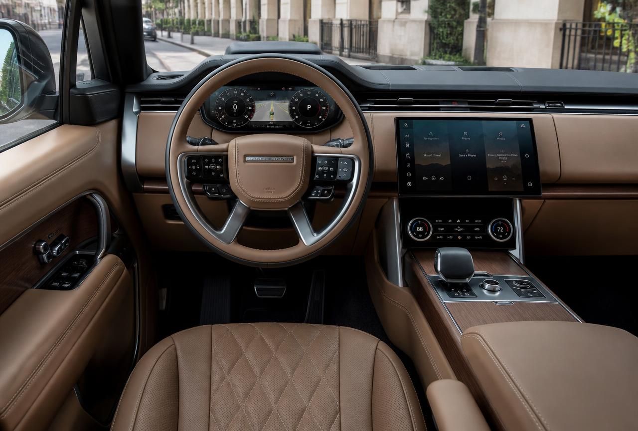 Range Rover interior cabin with quilted leather seats, digital driver display, and infotainment touchscreen
