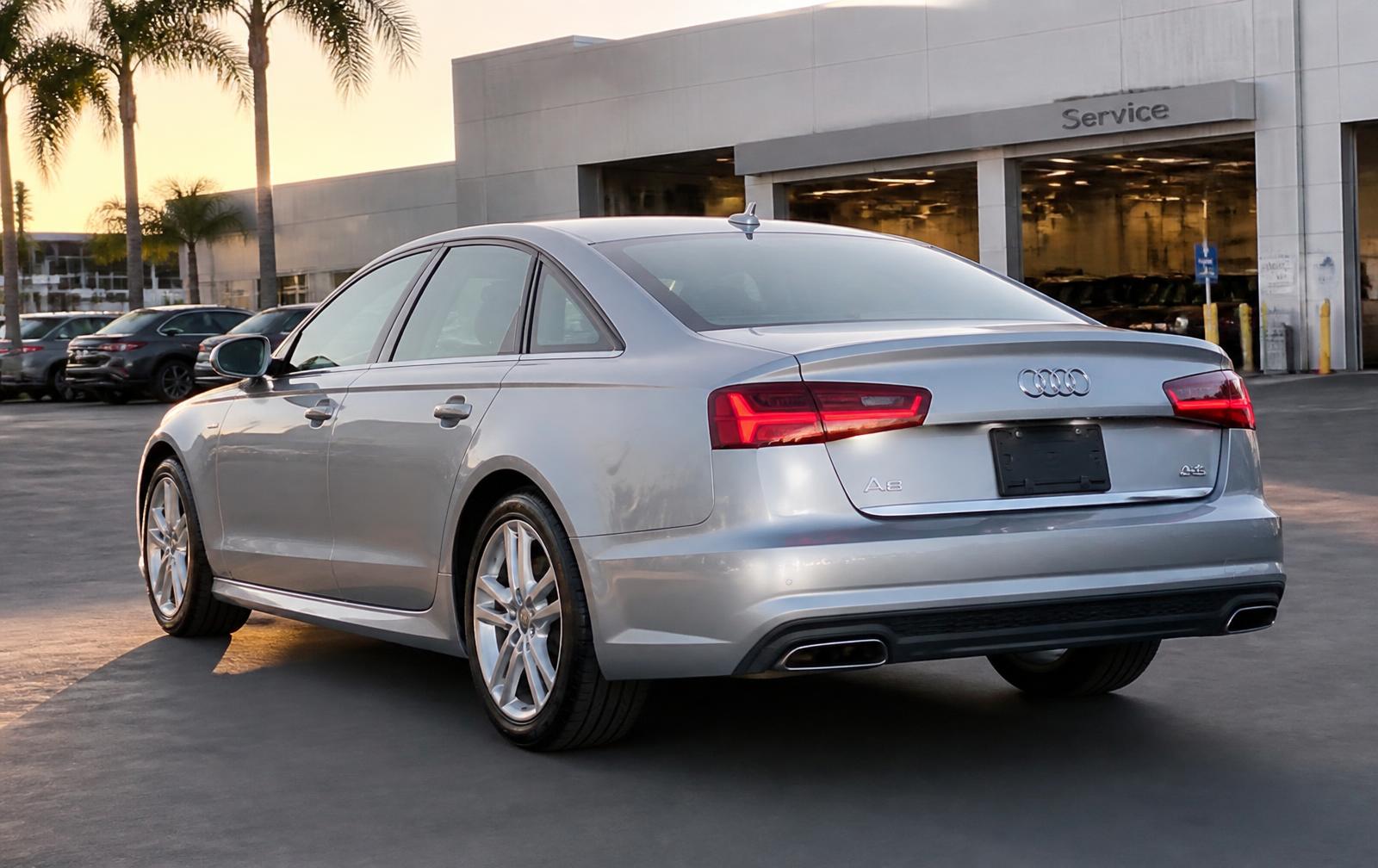 California Audi Lemon Law attorney reviewing dealership repair records with an Audi owner