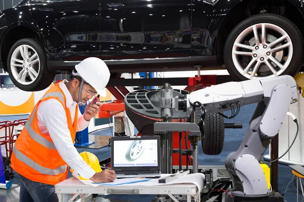 Automotive engineer inspecting vehicle